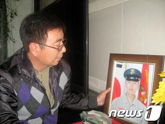 본문 이미지 - 고 문광욱 일병의 아버지 문영조씨가 아들의 사진을 보며 그리움에 눈시울을 붉히고 있다. © News1 김재수 기자