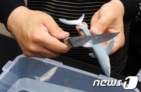 본문 이미지 - 한국동물보호연합과 녹색시민연대 회원들이 샥스핀(Shark's pin, 상어 지느러미) 요리의 판매 중단을 촉구하는 퍼포먼스를 벌이고 있다.  상어보호단체인 '퓨(PEW) 환경그룹'에 따르면 매년 7,300만마리의 상어가 샥스핀 요리 때문에 죽어간다.  © News1 오대일 기자