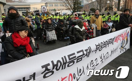 본문 이미지 - 지난 1월 서울 종로구 삼청동 금융연수원에 마련된 인수위원회 앞에서 전국장애인차별철폐연대 회원들이 장애등급제 폐지를 촉구하며 기자회견을 하고 있다. © News1 송원영 기자