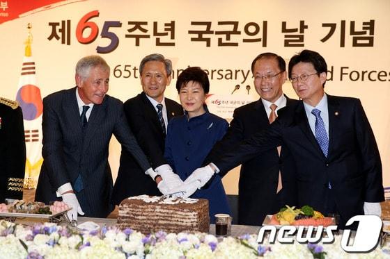 본문 이미지 - 박근혜 대통령이 지난 1일 오후 서울 종로구 세종문화회관에서 열린 건군 65주년 국군의 날 기념 경축연에 참석해 척 헤이글 미국 국방장관(왼쪽), 김관진 국방부 장관(왼쪽 두번째), 황우여 새누리당 대표(오른쪽 두번째), 유승민 국회 국방위원장(오른쪽) 등과 함께 기념떡을 자르고 있다. (청와대 제공) © News1 