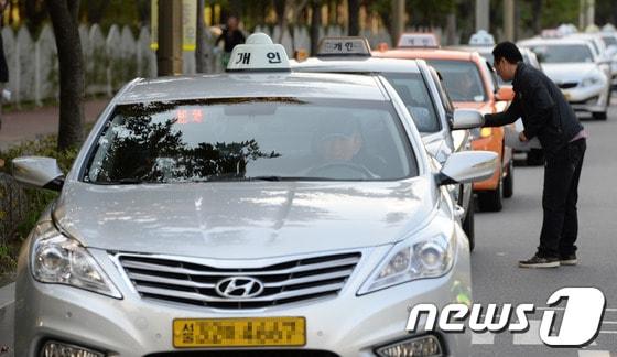 본문 이미지 - 서울택시 요금인상에 따라 14일 오후 작업장인 서울 마포구 난지천공원 주차장 앞에서 택시들이 미터기 조정작업을 기다리고 있다. 서울 택시는 지난12일부터 기본요금이 3천원으로 인상됐고, 시외로 나갈 경우 시외할증&#40;20%&#41;이 적용된다. 2013.10.14/뉴스1 © News1   박세연 기자