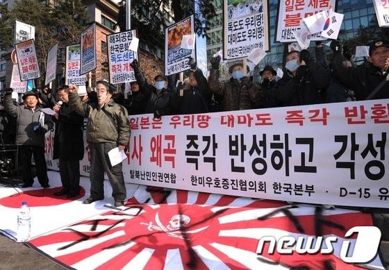 본문 이미지 - 어버이연합 등 보수단체 회원들이 1일 오후 서울 중학동 일본대사관 앞에서 일본의 독도 영토 주장을 규탄하는 3·1절 기념 기자회견을 개최한 가운데 아베 신조 일본총리의 탈을 쓴 한 회원이 일장기를 밟고 구호를 외치고 있다. 2013.3.1/뉴스1 © News1 박철중 기자