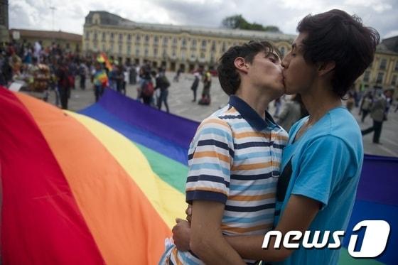 본문 이미지 - 콜럼비아 보고타에서 17일(현지시간) LGTB(레즈비언·게이·트렌스젠더·바이섹슈얼) 권리 운동가들이 콜럼비아 국회 앞에서 키스를 하며 시위하고 있다. © AFP=News1  