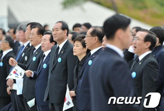 본문 이미지 - 박근혜 대통령이 18일 오전 광주 북구 운정동 5·18국립묘지에서 열린 5·18 민주화운동 33주년 기념식에 참석, 일부 참석자들이 합창단의 공연에 맞춰 '임을 위한 행진곡'을 따라부르자 자리에서 일어서 있다. 박근혜 대통령은 이날 노래를 부르지 않았다. 2013.5.18/뉴스1 © News1 정회성 