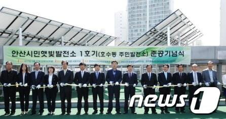 본문 이미지 - 김철민 안산시장 등이 21일 호수동  중앙도서관에서 열린 시민햇빛발전소 준공식에 참석해 기념 테이프를 자르고 있다./사진제공=안산시© News1  