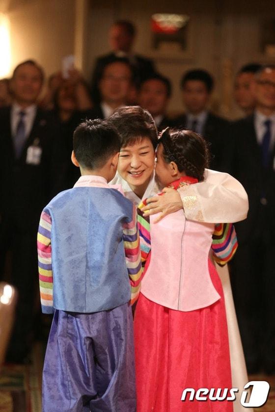 본문 이미지 - 미국을 방문중인 박근혜 대통령이 5일(현지시간) 미국 뉴욕 아스토리아호텔에서 열린 뉴욕동포 간담회에 참석해 화동으로부터 꽃다발을 받고 안아주고 있다. (청와대 블로그 제공) 2013.5.6/뉴스1 © News1 박철중 기자