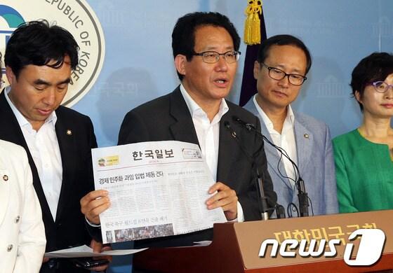 본문 이미지 - 국회 교육문화관광체육위원회, 환경노동위원회 소속 민주당 의원들이 19일 오후 서울 여의도 국회 정론관에서 기자회견을 열고 한국일보 정상화를 촉구하고 있다. 유기홍 의원이 오늘자 한국일보를 들어보이고 있다. 2013.6.19/뉴스1 © News1 허경 기자