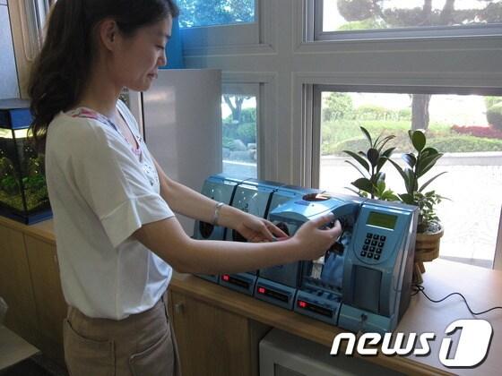 본문 이미지 - 19일 경남 산청군 민원실에 설치된 휴대폰 급속충전기를 민원인이 이용하고 있다.© News1 