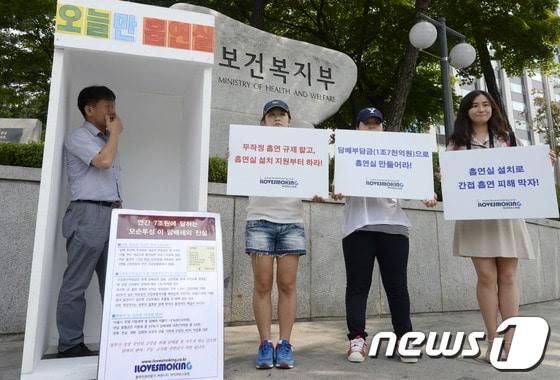 본문 이미지 - 흡연자 커뮤니티 '아이러브스모킹' 회원이 27일 오전 서울 종로구 계동 보건복지부 앞에서 공공장소 흡연실 설치를 촉구하며 임시 흡연실을 설치해 흡연을 하고 있다. © News1 안은나 기자