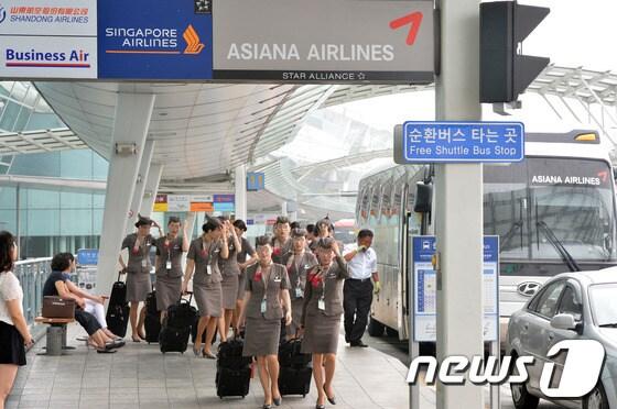 본문 이미지 - 미국 샌프란시스코 국제공항에서 6일(현지시간) 아시아나항공 OZ 214편 여객기가 착륙 중 충돌사고 발생한 가운데 7일 오후 인천국제공항 국제선탑승 출구로 아시아나 승무원들이 들어가고 있다. 2013.7.7/뉴스1 © News1   최영호 기자