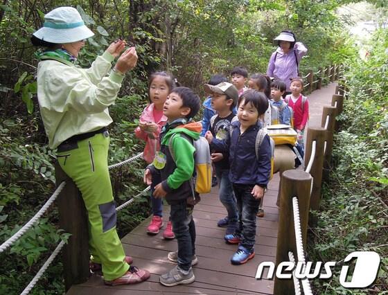 본문 이미지 - 숲해설사가 아이들에게 숲에 대한 설명을 하고 있다.  2014.2.19/뉴스1 © News1   하중천 