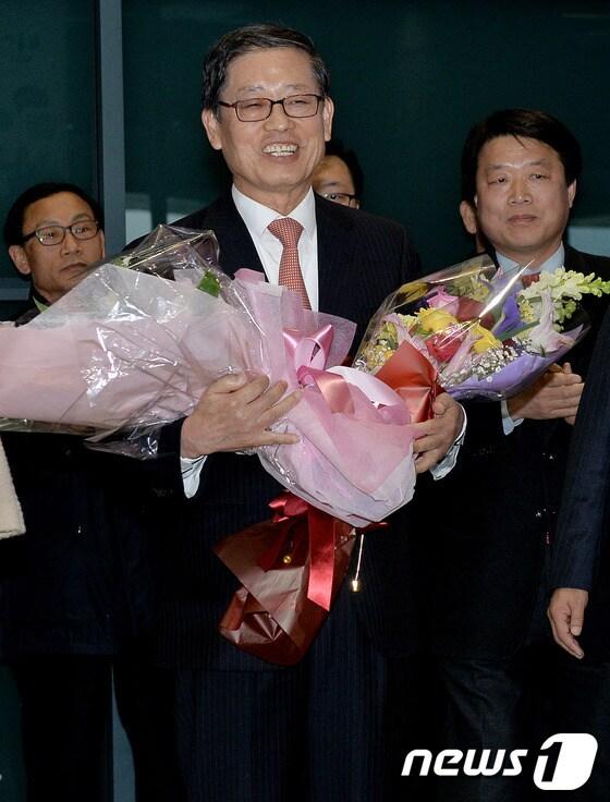 본문 이미지 - 서울시장 출마를 공식선언한 김황식 전 총리가 14일 오후 인천국제공항을 통해 귀국하며 지지자들로부터 꽃다발을 받고 있다.김 전 총리는 