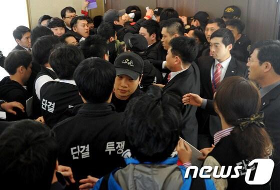 본문 이미지 - 28일 강원랜드 노동조합 조합원들이 강원랜드 컨벤션홀에서 이사회 출입을 요구하며 출입을 막는 요원들과 몸싸움을 하고 있다.  2014.3.28/뉴스1 © News1   하중천 