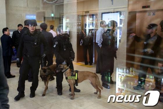 본문 이미지 - 31일 오후 서울 중구 여성가족부에 폭발물이 설치됐다는 신고를 받고 출동한 경찰특공대 대원들과 폭발물탐지견이 건물 내부를 수색하고 있다. 경찰은 이날  신고자로부터 온라인 커뮤니티 일베저장소(일베) 게시글을 바탕으로 한 폭발물 설치 신고를 받고 수색에 나섰지만 폭발물로 의심되는 물질은 발견되지 않았다. 2014.3.31/뉴스1 © News1   한재호 기자