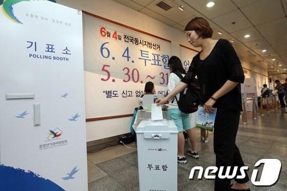 본문 이미지 - 지난 13일 오전 서울 종로구 혜화역전시관에 설치된 6·4 지방선거 사전투표 체험관을 찾은 시민들이 모의투표를 하고 있다. 2014.5.13/뉴스1 © News1   한재호 기자