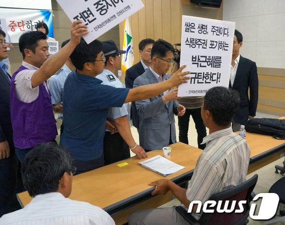 본문 이미지 - 전국농민회총연맹 강원도연맹 회원들이 18일 오후 농림축산식품부 주최로 열린 쌀 관세화 유예 종료 강원권 설명회에서 손 피켓을 들고 관계자들에게 항의를 하고 있다. 2014.6.18/뉴스1  © News1   이예지 기자
