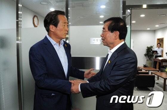 본문 이미지 - 6·4 지방선거에서 치열한 경합을 벌였던 박원순 서울시장과 정몽준 전 의원이 지난 19일 서울시장 집무실에서 선거 후 처음 다시 만나 악수를 나누고 있다. 정 전 의원은 이 자리에서 