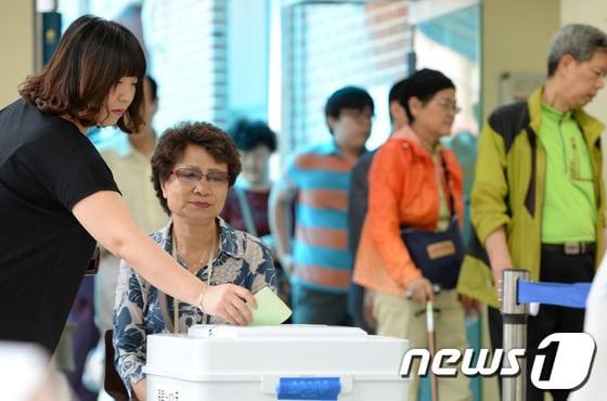 본문 이미지 - 제6회 전국동시지방선거일인 4일 오후 서울 종로구 효제초등학교에 마련된 종로1-4가동 제1투표소에서 시민들이 투표를 하고 있다. 2014.6.4/뉴스1 © News1   민경석 기자