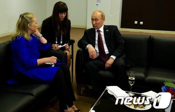 본문 이미지 - 2012년 러시아에서 열린 APEC 정상회담에서 푸틴 대통령과 힐러리 클린턴 전 미국 국무장관이 대화를 나누고 있다. © AFP=뉴스1 