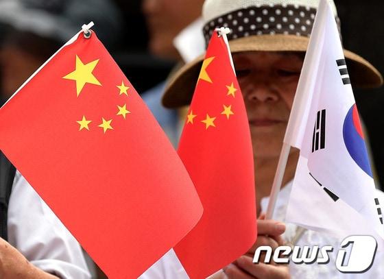 본문 이미지 - 2014년 시진핑 중국 국가주석 방한을 앞두고 태극기와 오성홍기를 든 보수단체 회원들 (자료사진) /뉴스1
