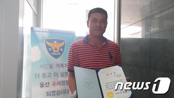본문 이미지 - 울산 남부경찰서는 28일 &acute;묻지마 살인사건&acute; 피의자를 붙잡은 공로로 시민 이대식씨에게 감사장과 소정의 선물을 전달했다. ⓒ News1 남미경 기자