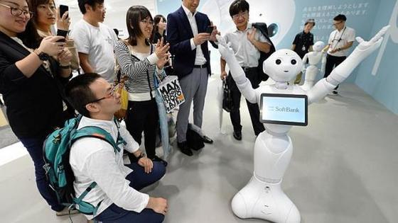 본문 이미지 - 관람객들이 소프트뱅크 사내에서 인간형 로봇 페퍼를 보고 있다 © AFP=News1 