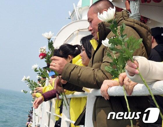 본문 이미지 - 세월호 참사 1주기를 하루 앞둔 15일 세월호 희생자 유족들이 전남 진도군 조도면 인근 세월호가 침몰한 사고해역을 방문, 헌화를 하고 있다. 2015.4.15/뉴스1 2015.04.15/뉴스1 ⓒ News1 윤용민 기자