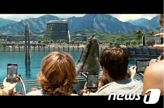 본문 이미지 - 쥬라기월드 예고편에서 등장인물들이 삼성전자 모바일 기기를 이용해 사진을 찍고 있다.ⓒ News1
