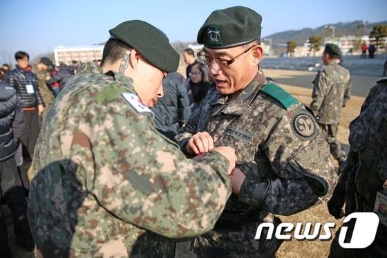 본문 이미지 - 7일 39사단 신병수료식을 마친 김승빈 이병이 문병호 39사단장에게 감사브로치를 달아주고 있다(39사단제공)2016.1.7/뉴스1 ⓒ News1 이철우 기자