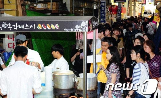 본문 이미지 - 24일 오후 전북 전주시 남부시장 야시장을 찾은 사람을이 총각네 스시 영업시작을 기다리며 줄을 서 있다.2016.6.24/뉴스1 ⓒ News1 문요한 기자