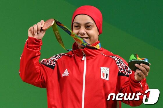 본문 이미지 - 사라 아흐메드 이집트 국가대표가 10일(현지시간) 여자 역도 69kg급에서 225kg를 들어올려 아랍권 출신 무슬림 여성 최초로 동메달을 목에 걸었다. ⓒ AFP=뉴스1