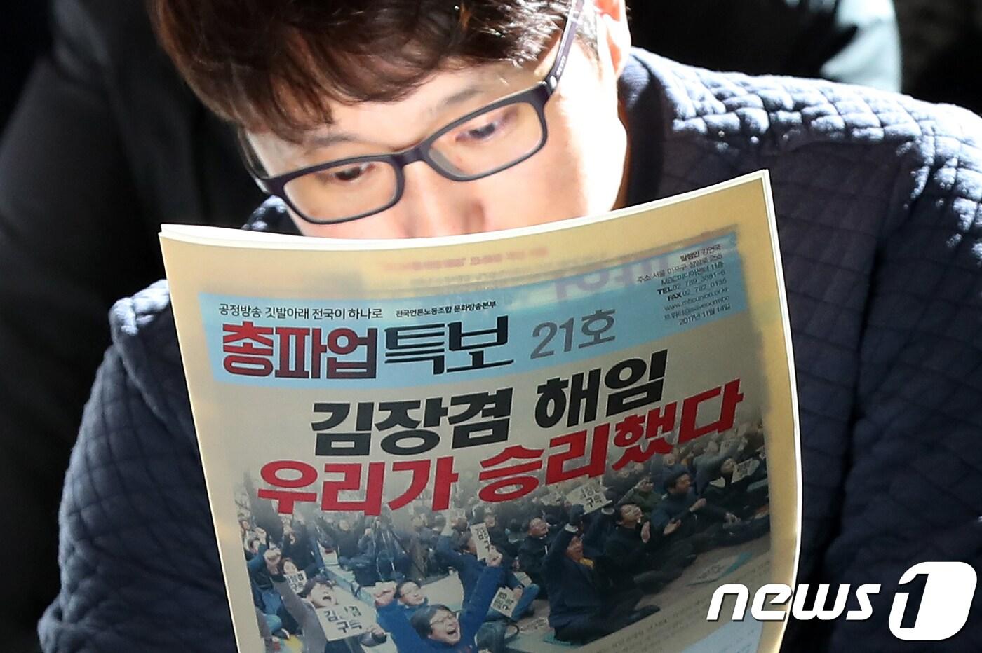 지난 14일 전국언론노동조합 MBC본부 조합원이 서울 마포구 상암동 MBC 사옥 로비에서 총파업 중단 발표 현장에서 총파업 특보를 읽고 있다.2017.11.14/뉴스1 ⓒ News1 민경석 기자