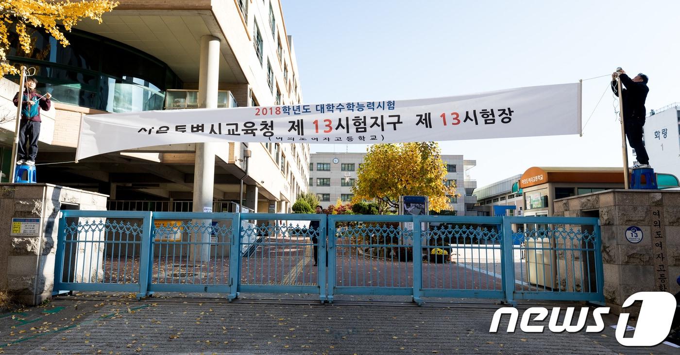 본문 이미지 - 포항지진 여파로 대학수학능력시험이 연기된 16일 서울 여의도의 한 수능시험장에서 학교관계자들이 수능시험장 현수막을 철거하고 있다. 2017.11.16/뉴스1 ⓒ News1 유승관 기자