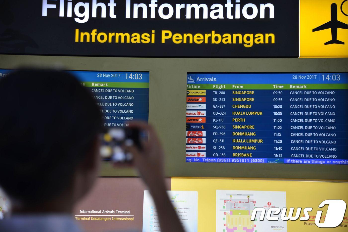 인도네시아 발리 응우라라이 공항에서 결항된 항공편 알림판을 바라보는 이용객.ⓒ AFP=뉴스1