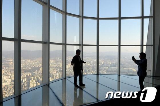 본문 이미지 - 14일 서울 송파구 롯데월드타워 전망대 '서울스카이(SEOUL SKY)에서 사전 초대를 받은 시민들이 전망을 즐기고 있다. 오는 22일 오픈하는 '서울스카이'는 지상에서 500m 높이, 롯데월드 타워 117~123층 총 9개 층으로 구성됐다. 2017.3.14/뉴스1 ⓒ News1 황기선 기자
