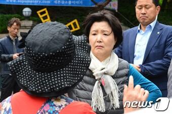본문 이미지 - 13일 오후 서울 서대문구 홍은동 문재인 대통령 사저 앞에서 한 시민이 자신의 억울함을 소리치자 부인 김정숙 여사가 밖으로 나와 이야기를 들어주고 있다. 이날 부인 김정숙 여사는 한 시민이 &#34;배고프다. 밥도 못 먹고 여기에 왔다. 내 억울함을 들어달라&#34;는 말에 음식을 내어주며 이야기를 들어주는 모습을 보였다. 2017.5.13/뉴스1 ⓒ News1 임세영 기자