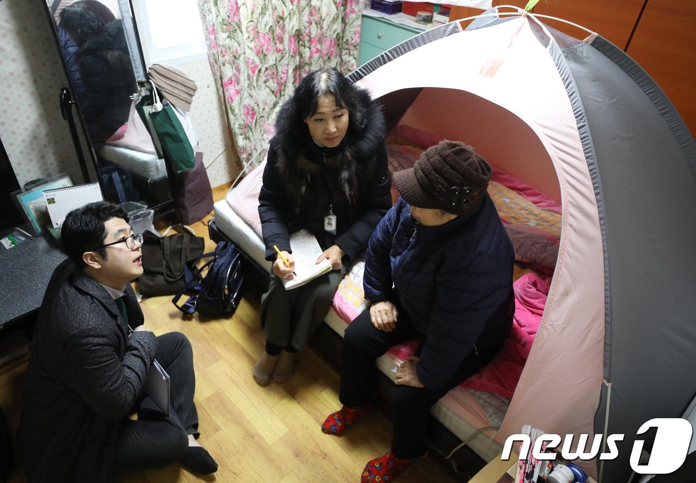 본문 이미지 - 김성은 구로5동 주무관(사회복지공무원)과 임영자 구로5동 간호사가 지역의 한 독거노인 세대를 방문해 건강상태를 점검하고 있는 모습. . 2018.12.13/뉴스1 ⓒ News1 허경 기자