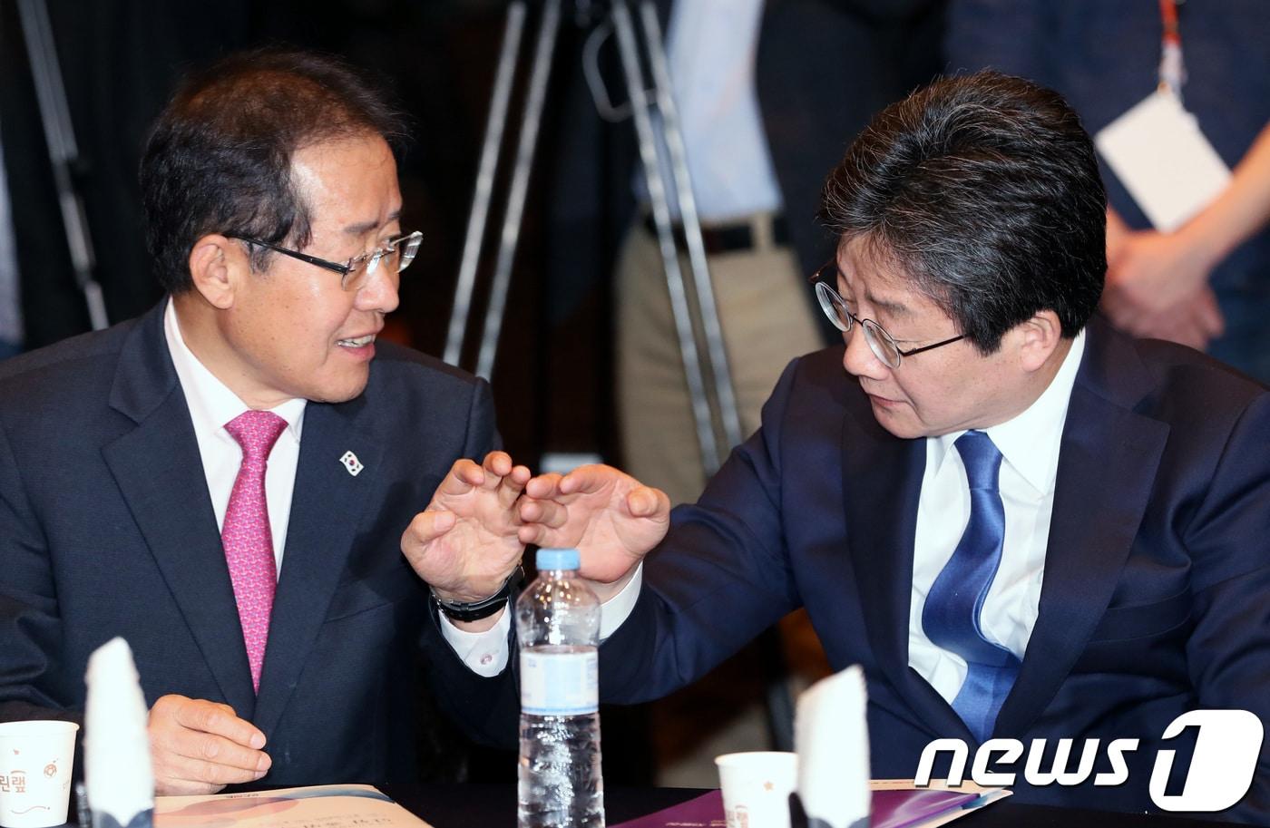 본문 이미지 - 2018년 4월 12일 당시 홍준표 자유한국당 대표와 유승민 바른미래당 공동대표가 서울 여의도 중소기업중앙회 그랜드홀에서 열린 소상공인연합회 단합 출범식에서 대화를 나누고 있다. 2018.4.12/뉴스1 ⓒ News1 DB