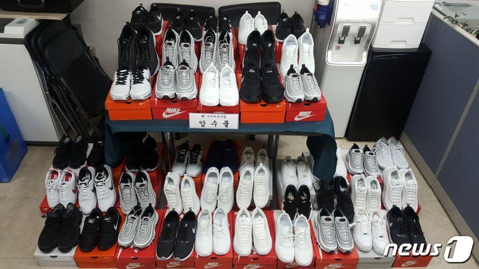 본문 이미지 - 서울 종암경찰서 가 17일 '나이키'의 가품 운동화를 정품으로 속여 판쇼핑몰 운영자 김모씨에게서 압수한 짝퉁운동화를 공개하고 있다..(서울 종암경찰서 제공) 2018.4.17/뉴스1 ⓒ News1