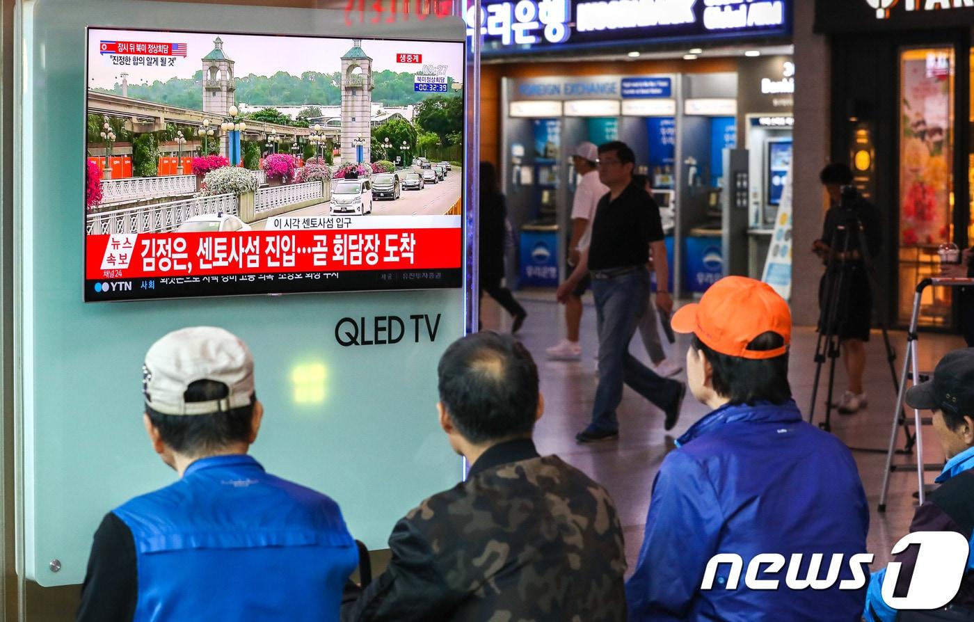 본문 이미지 - 북미정상회담을 앞두고 있는 12일 오전 서울역에서 시민들이 트럼프 미국 대통령과 김정은 북한 국무위원장이 차량을 이용해 북미정상회담장인 싱가포르 센토사 섬으로 진입하는 모습을 시청하고 있다. 2018.6.12/뉴스1 ⓒ News1 성동훈 기자