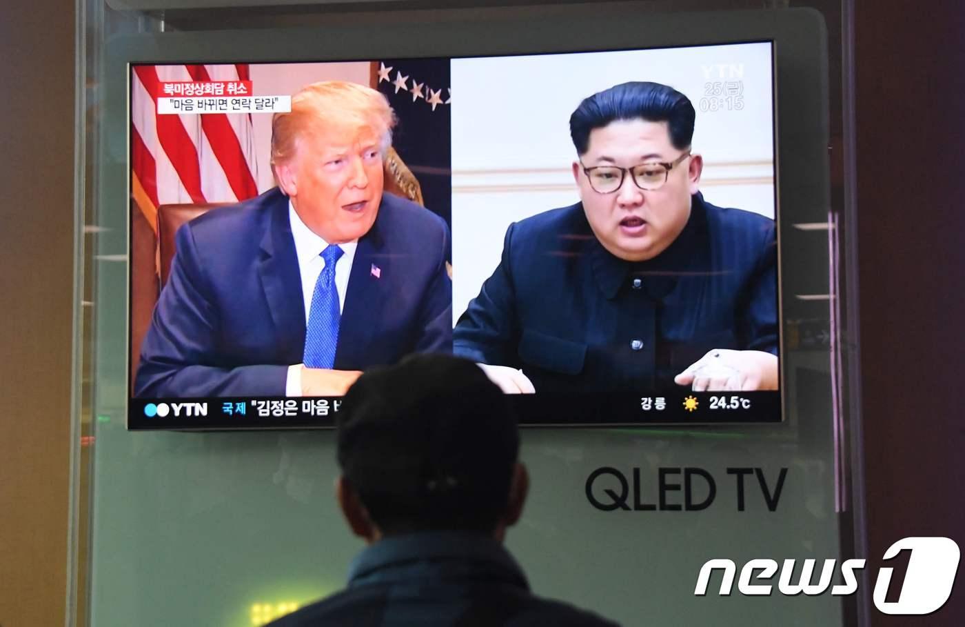 지난달 25일 한 시민이 서울역 대합실에서 도널드 트럼프 미국 대통령(왼쪽)과 김정은 북한 국무위원장의 모습이 나오는 TV 뉴스를 시청하고 있다. ⓒ AFP=뉴스1