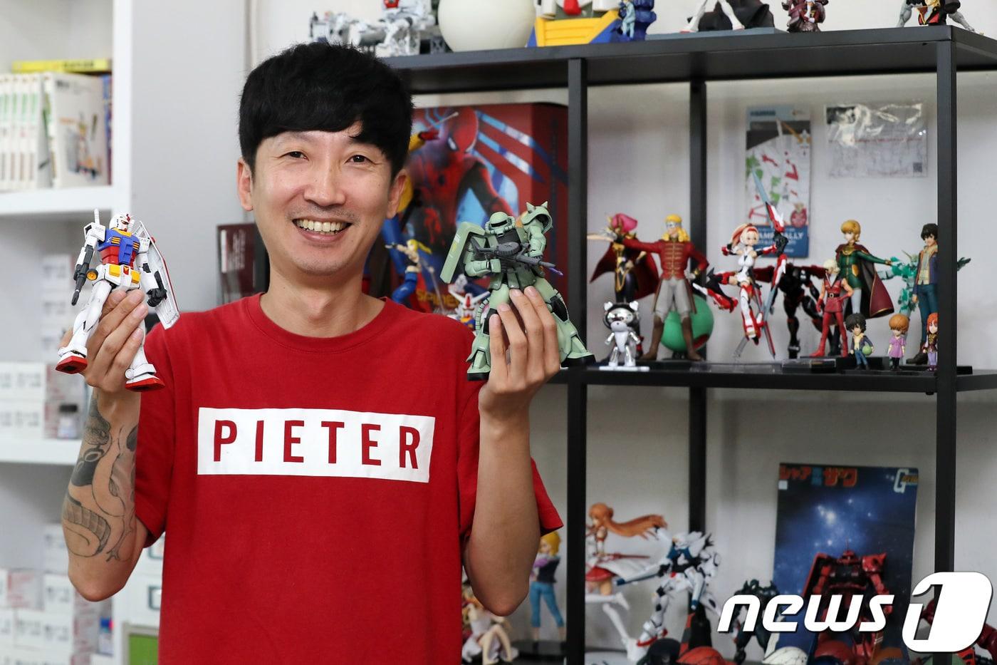 본문 이미지 - 이성동 건프라연구소 소장이 20일 오후 서울 마포구 건프라연구소 공방에서 건담 프라모델을 들고 포즈를 취하고 있다. 2018.7.21/뉴스1 ⓒ News1 박지수 기자