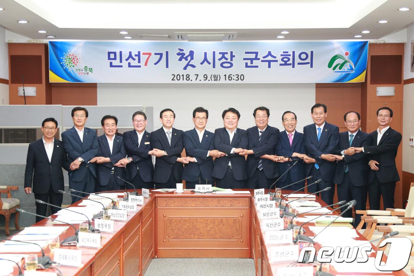 본문 이미지 - 민선 7기 충북 첫 시장·군수 회의가 9일 도청 소회의실에서 열렸다. 회의에 참석한 단체장들이 손을 맞잡고 기념촬영을 하고 있다. 왼쪽부터 이차영 괴산군수, 홍성열 증평군수, 송기섭 진천군수, 박세복 영동군수, 조길형 충주시장, 이시종 충북지사, 한범덕 청주시장, 이상천 제천시장, 정상혁 보은군수, 김재종 옥천군수, 류한우 단양군수, 조병옥 음성군수.(충북도 제공) 2018.7.9./뉴스1 ⓒ News1