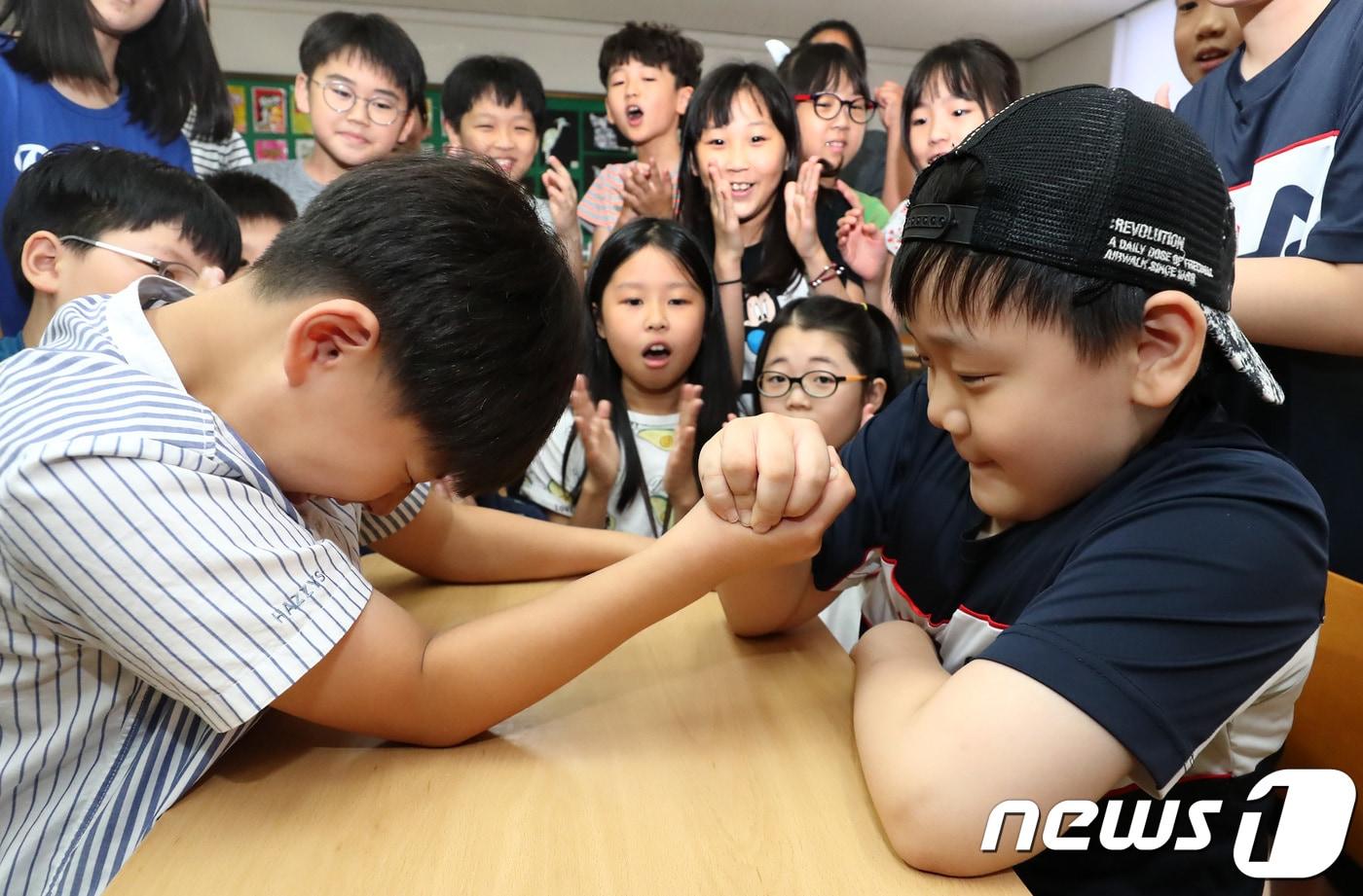 본문 이미지 - 13일 오전 경기도 용인시 수지초등학교 4학년 3반 교실에서 여름방학을 마치고 오랜만에 만난 학생들이 방학동안 달라진 힘을 겨뤄보기 위해 팔씨름을 하고 있다. (기사내용과 관계없음) 2018.8.13/뉴스1 ⓒ News1 오장환 기자