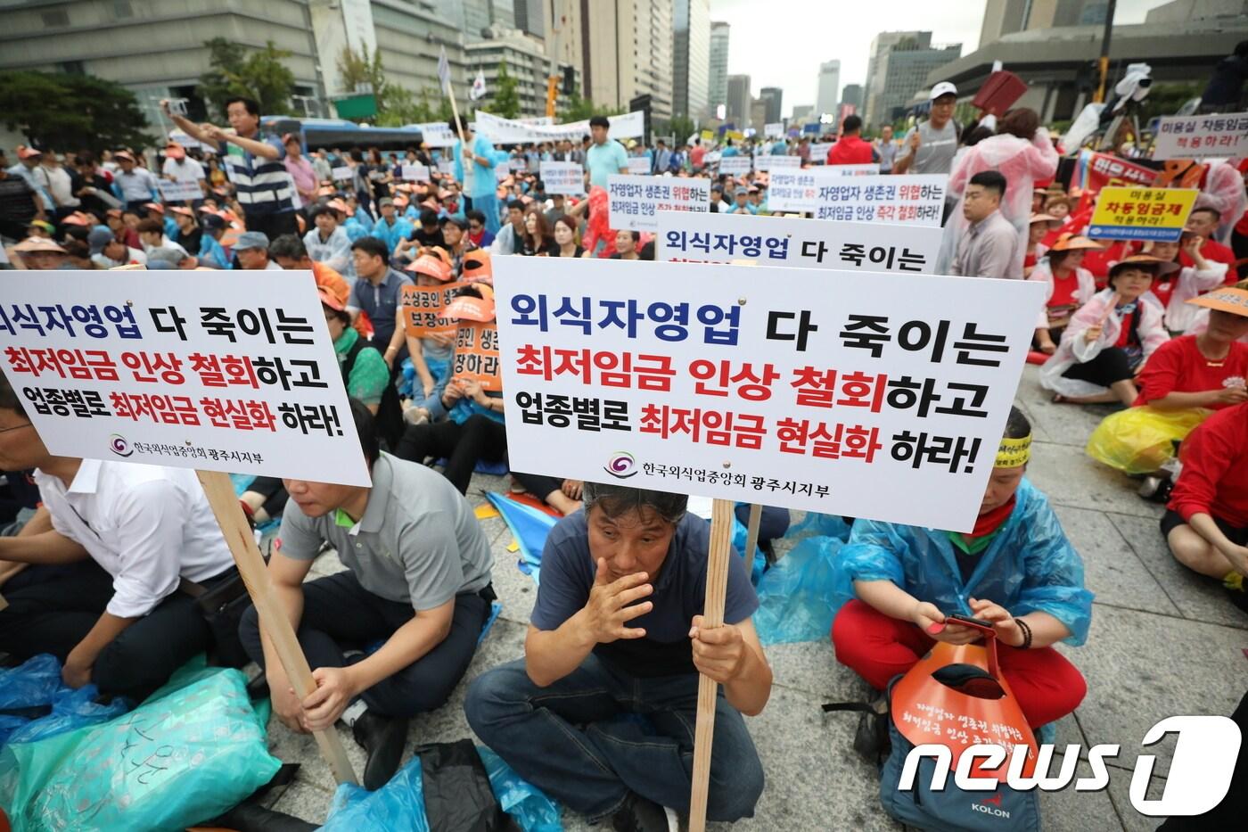 본문 이미지 - 29일 서울 광화문광장에서 열린 소상공인 생존권 운동연대 주최 ‘최저임금 제도개선 촉구 국민대회’에서 참가자들이 최저임금 인상 철회를 주장하며 손피켓을 들고 있다. 2018.8.29/뉴스1 ⓒ News1 성동훈 기자