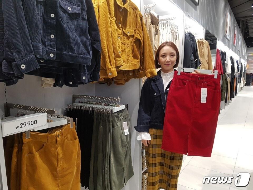 본문 이미지 - GU의 국내 1호점인 GU롯데월드몰점에서 13일 GU어드바이저가 빨강 코듀로이 스커트를 소개하고 있다. ⓒ News1/정혜민 기자