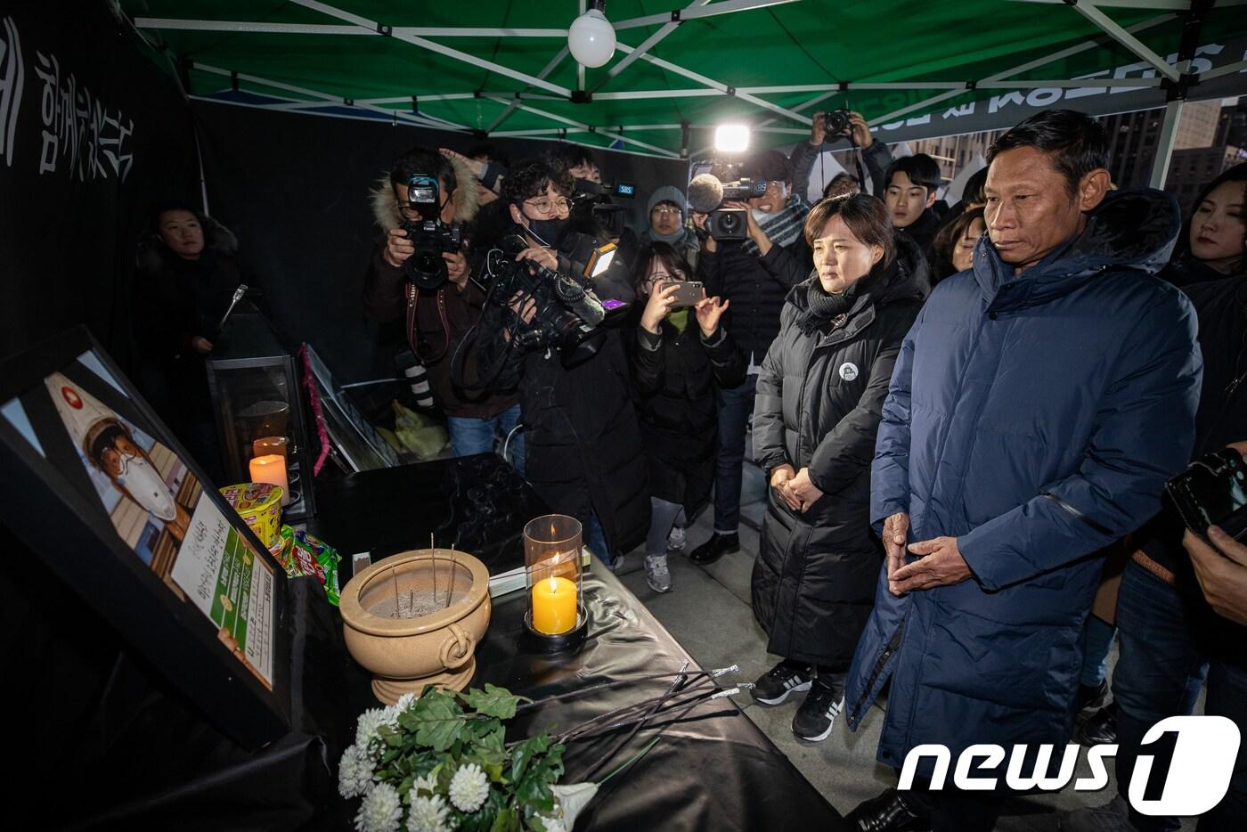 본문 이미지 - 고(故) 김용균 씨의 어머니 김미숙 씨가 지난 1월2일 서울 광화문광장에 마련된 김씨의 분향소에서 미얀마 노동자 고 딴탄테이의 아버지 깜칫을 만나 김씨의 영정을 바라보고 있다. 2019.1.2/뉴스1 ⓒ News1 유승관 기자