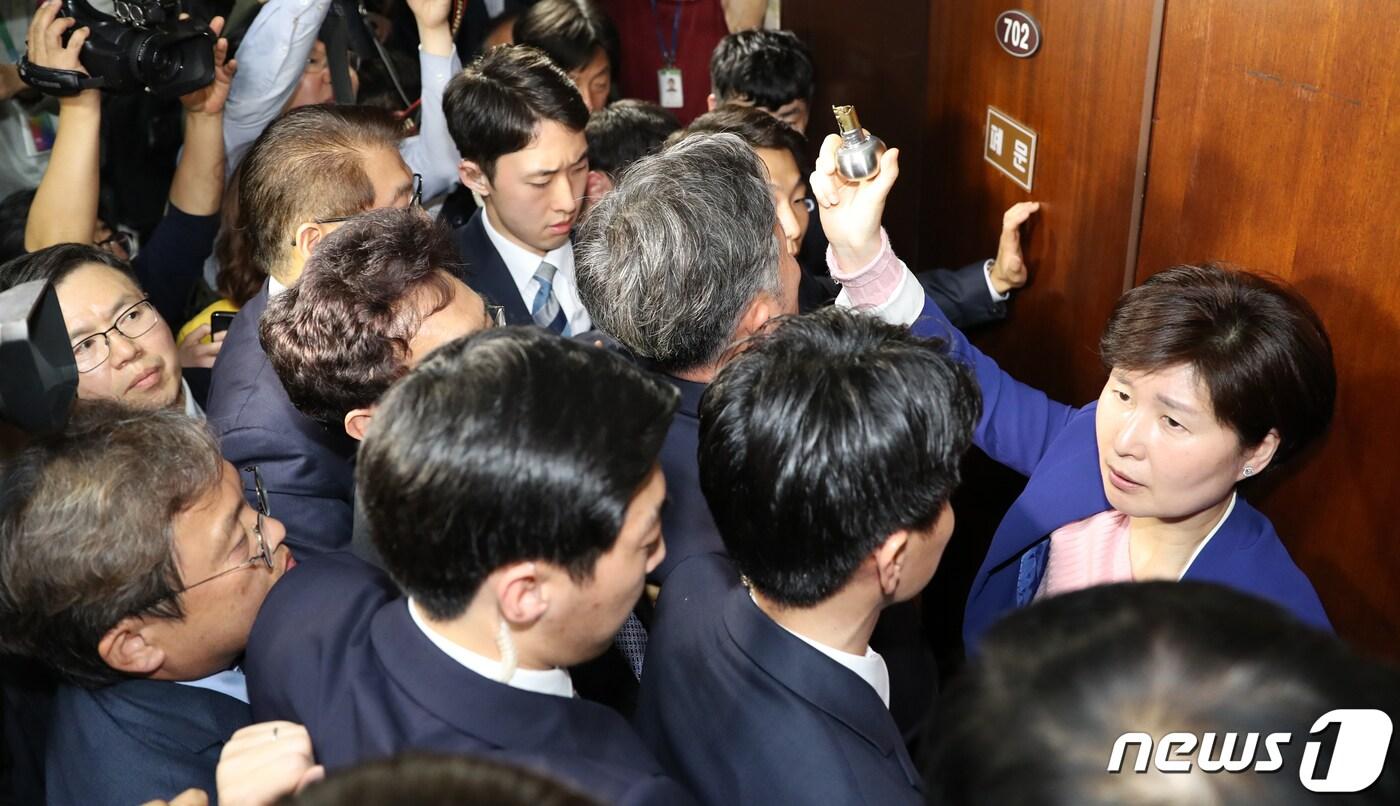 본문 이미지 - 강병원,표창원,백혜련 등 더불어민주당 의원들이 지난해 4월25일 오후 서울 여의도 국회 의안과에 공수처법을 제출하다 이를 막는 자유한국당(미래통합당 전신) 의원들과 충돌했다. 백혜련 의원이 떨어져나간 의안과 손잡이를 들어보이고 있다. 2019.4.25/뉴스1 ⓒ News1 이종덕 기자