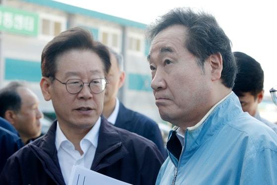 본문 이미지 - 2019년 9월 18일 당시 이낙연 국무총리가 이재명 경기도지사와 함께 경기 포천시 거점세척 소독시설을 찾아 아프리카 돼지열병과 관련해 대화하고 있다. ⓒ News1 