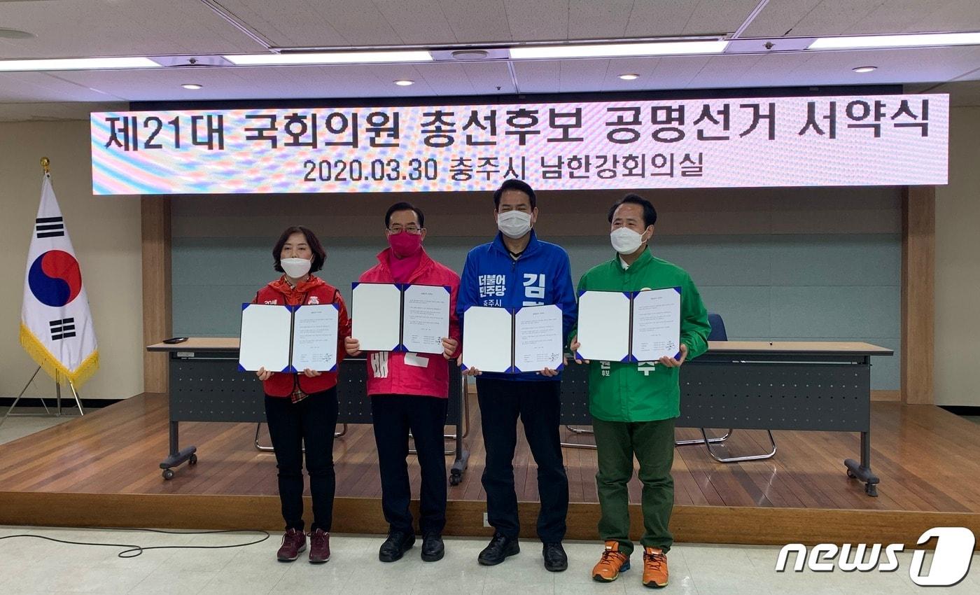 본문 이미지 - 30일 4·15 총선 충주선거구에 출마하는 후보들이 공명선거 협약을 하고 있다. 왼쪽부터 개혁당 김은숙 후보, 통합당 이종배 후보, 민주당 김경욱 후보, 민생당 최용수 후보.2020.03.30/ⓒ 뉴스1